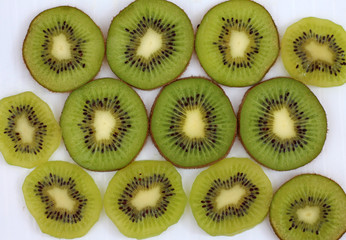 slices of ripe and juicy kiwi ON white surface