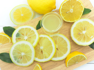 Fresh lemon slice with lemonade on white wood background