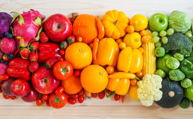 Fototapeta na wymiar Colorful fresh fruits and vegetables on wood background, healthy eating concept.