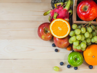Colorful fresh fruits and vegetables on wood background, healthy eating concept.