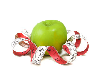 Measuring tape and fresh green apple on white background. Healthy food and lifestyle concept.