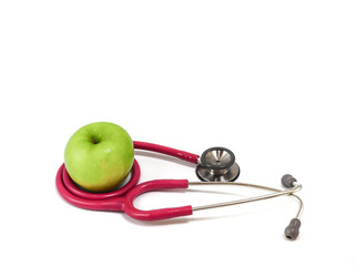 Stethoscope and fresh green apple on white background. Healthy food and lifestyle concept.
