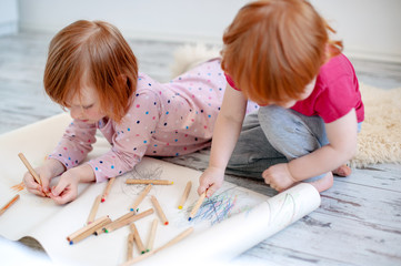 Children draw with colored pencils