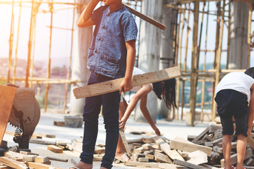 Children working at construction site for world day against children labour concept: