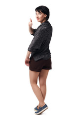 young woman posing in studio on white background, wearing brown shorts and shirt