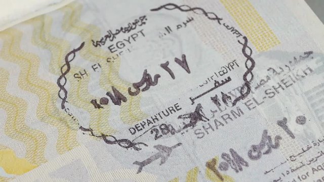 Egypt passport stamp. Entry stamps in passport page. International passports with visas. Elevated view of Egypt entry visa fee