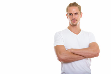 Studio shot of young handsome man with arms crossed