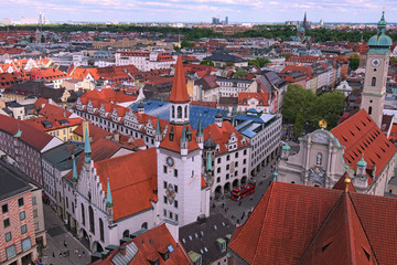 Fototapeta na wymiar Munich historical center panoramic aerial cityscape. Old City Hall, Heiliggeist Church (Heiliggeistkirche) and red tile roofs of ancient building at spring day. Bavaria, Germany