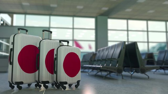 Travel suitcases featuring flag of Japan. Japanese tourism conceptual animation