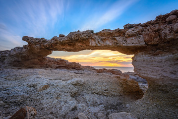 Fototapeta na wymiar Natural arch of Portinatx at sunset, Ibiza, Spain