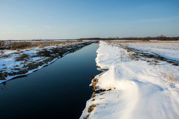 Snowdrift and river bank