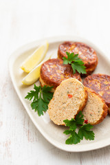 fish balls with lemon on dish on wooden background