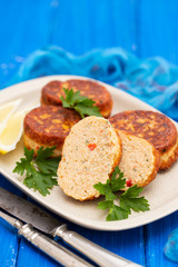 fish balls with lemon on dish on wooden background
