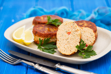 fish balls with lemon on dish on wooden background