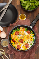 omelet with potato, peas and smoked sausages