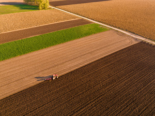 Aerial shot of a farmer plowing stubble field © oticki