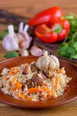 Uzbek pilaf on wooden background
