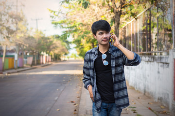 Man walking on the sidewalk talking on the mobile phone.