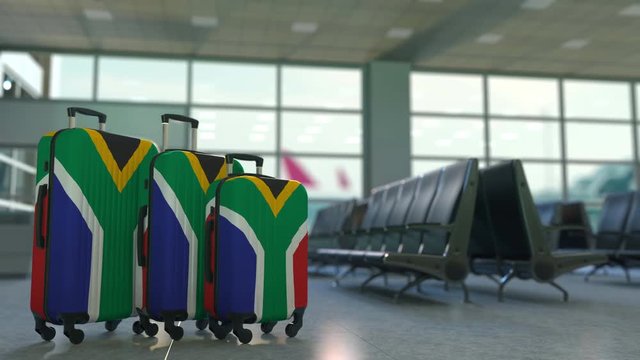 Travel suitcases featuring flag of South Africa. SAR tourism conceptual animation