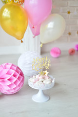 One year birthday decorations. Decorations for holiday party. A lot of balloons pink and white colors. Cake for birthday party. 