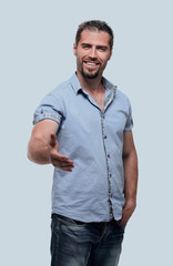 Fototapeta premium stylish young man holds out his hand for a handshake.