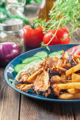 Greek gyros dish with french fries and vegetables