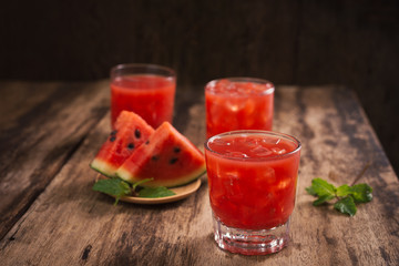 Refreshing summer watermelon juice in glasses with slices of watermelon