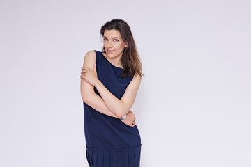 portrait of a beautiful brunette girl in a dress on a white background in different poses