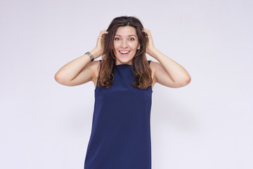 portrait of a beautiful brunette girl in a dress on a white background in different poses