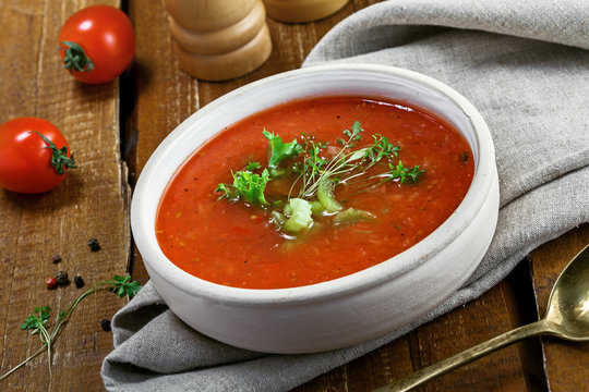 Gazpacho and ingredients on a table, vegetable soup. Delicious Spanish vegan cuisine.