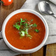 Gazpacho and ingredients on a table, vegetable soup. Delicious Spanish vegan cuisine. Top view.