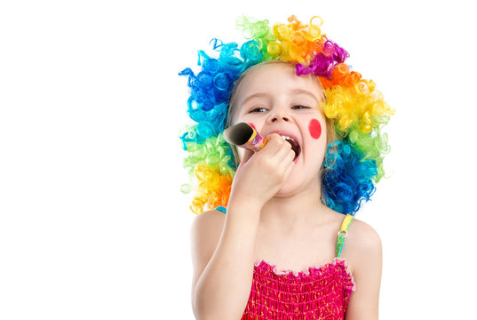 Profile view of little girl in clown wig