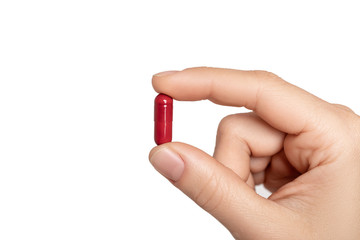pill in man's hand on white background