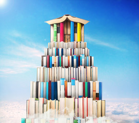 Сoncept of education. Stack of books in the form of a ladder with library compiled from the books on a sky background. Сoncept of learning. Achievement.