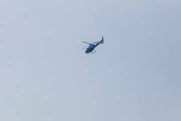 Helicopter flying in blue sky