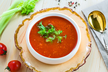Delicious gazpacho and ingredients on a table. Vegetarian vegetable cold soup. Top view.