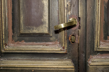Part of a 17th century wooden door with brass handle. Background