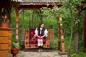 Portrait of a beautiful young woman wearing traditional Romanian clothes, in Maramures