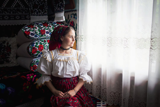 Portrait of a beautiful young woman wearing traditional Romanian clothes, in Maramures