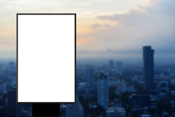 white blank poster frame standing on blur night city background for show content,product,text and mock up design concept