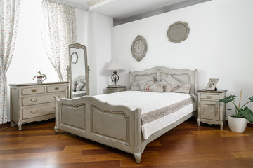 Fototapeta na wymiar interior of modern light bedroom with white and grey furniture