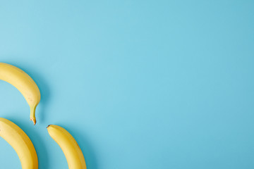 top view of arranged fresh bananas isolated on blue