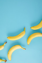 top view of arranged fresh bananas isolated on blue