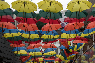 Fototapeta na wymiar Coloured umbrellas hanging in the shopping centre of Kingston upon Thames
