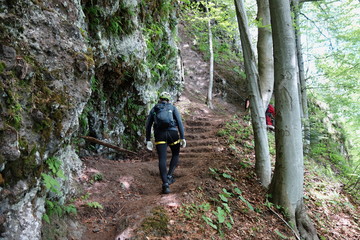 Hikers in a dangerous pathway - via ferrata in the mountain resort Skalka in Kremnica mountains-...