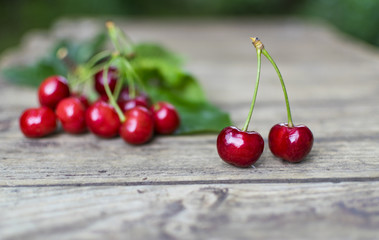 Freshly picked, delicious  cherries on old wooden table