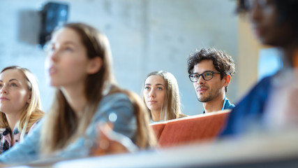 Attentive Hispanic Student Listening to a Lecture Among His Fellow Students in thу Classroom on...