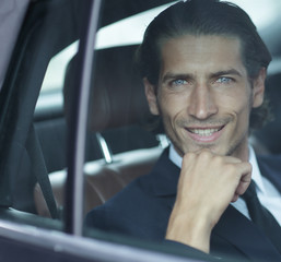 face of a businessman sitting in car