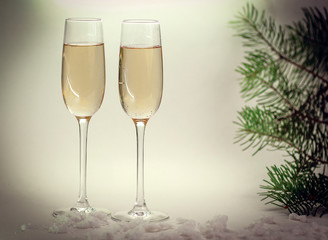 two glasses with champagne on Christmas background