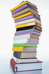 pile of colored books on white surface